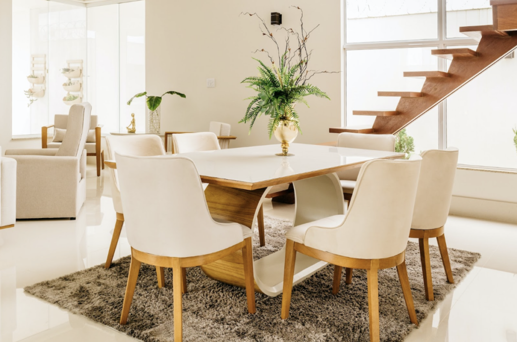 Salon lumineux et moderne avec une jolie table minimaliste et originale et une plante dessus.