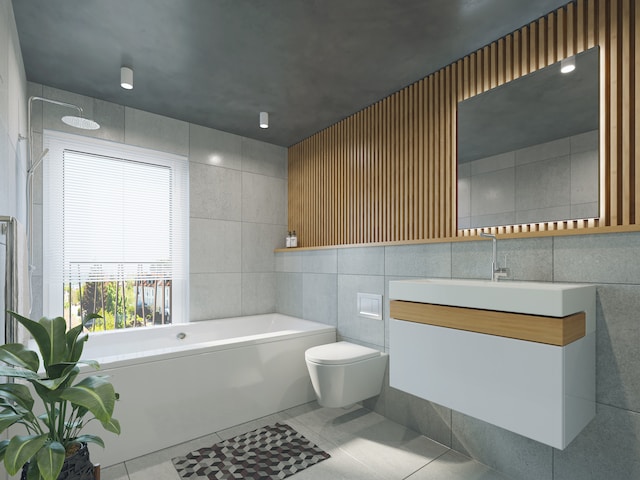 Salle de bain avec une baignoire collé au mur.